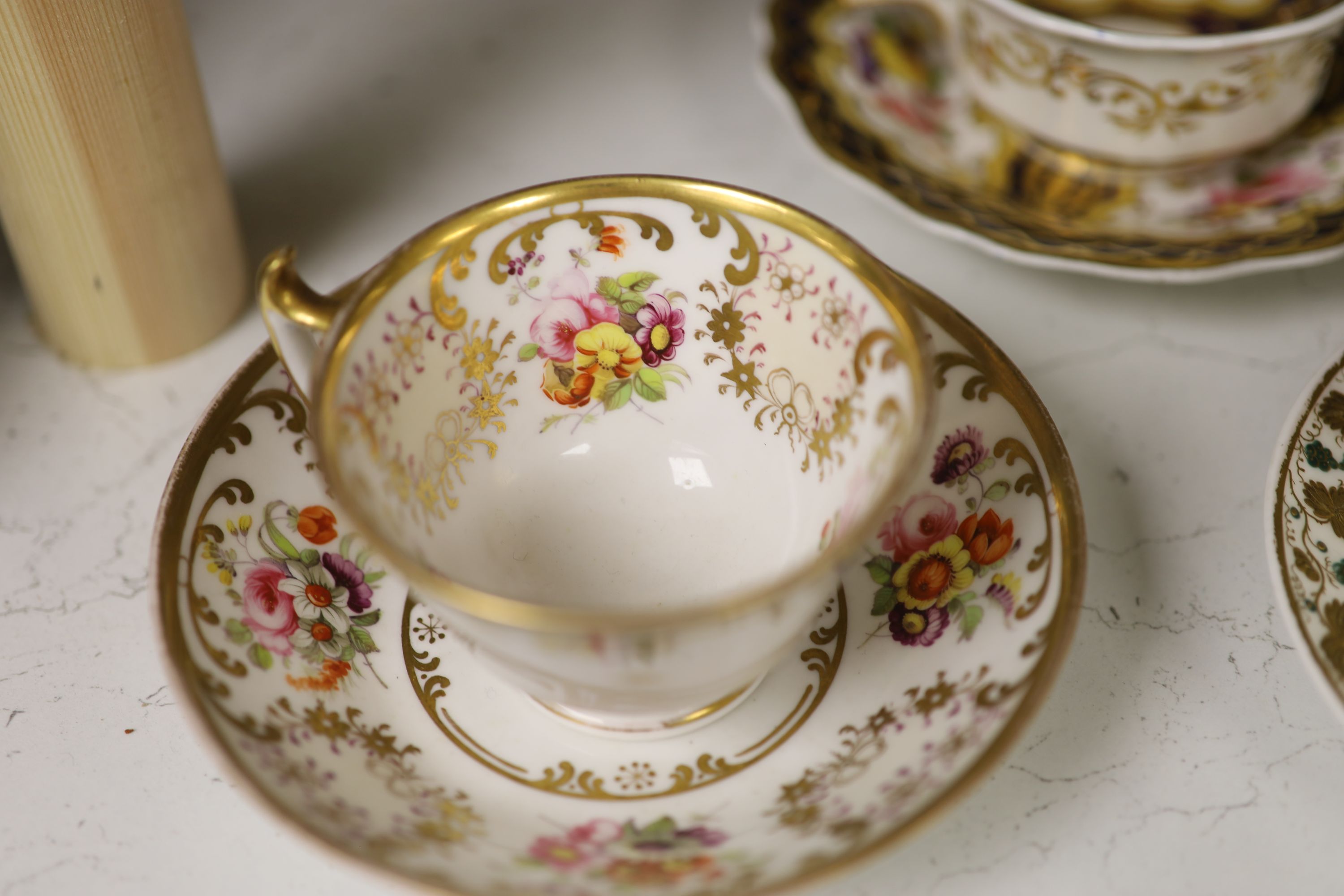 A Spode cup and saucer decorated with raised gilt birds and a basket with green leaves, marked Spode 3916, a Copeland and Garrett turqu